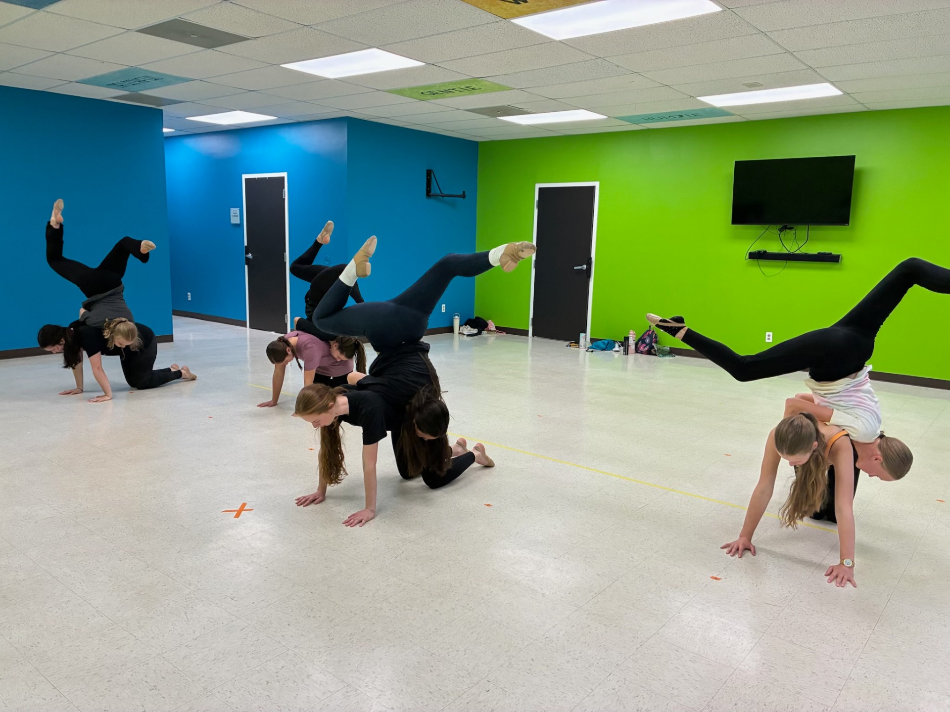 Teen dancers in acro handstand practice