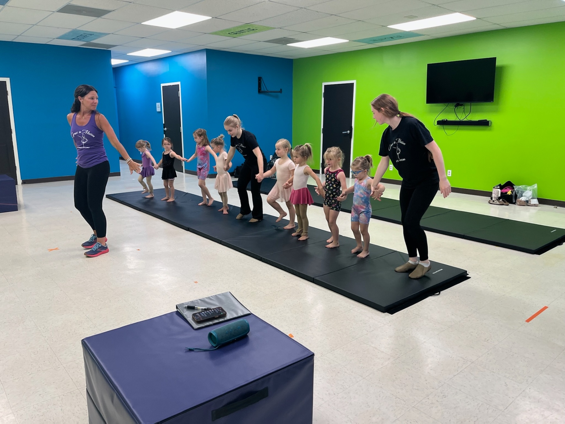 Instructors leading a preschool combo class