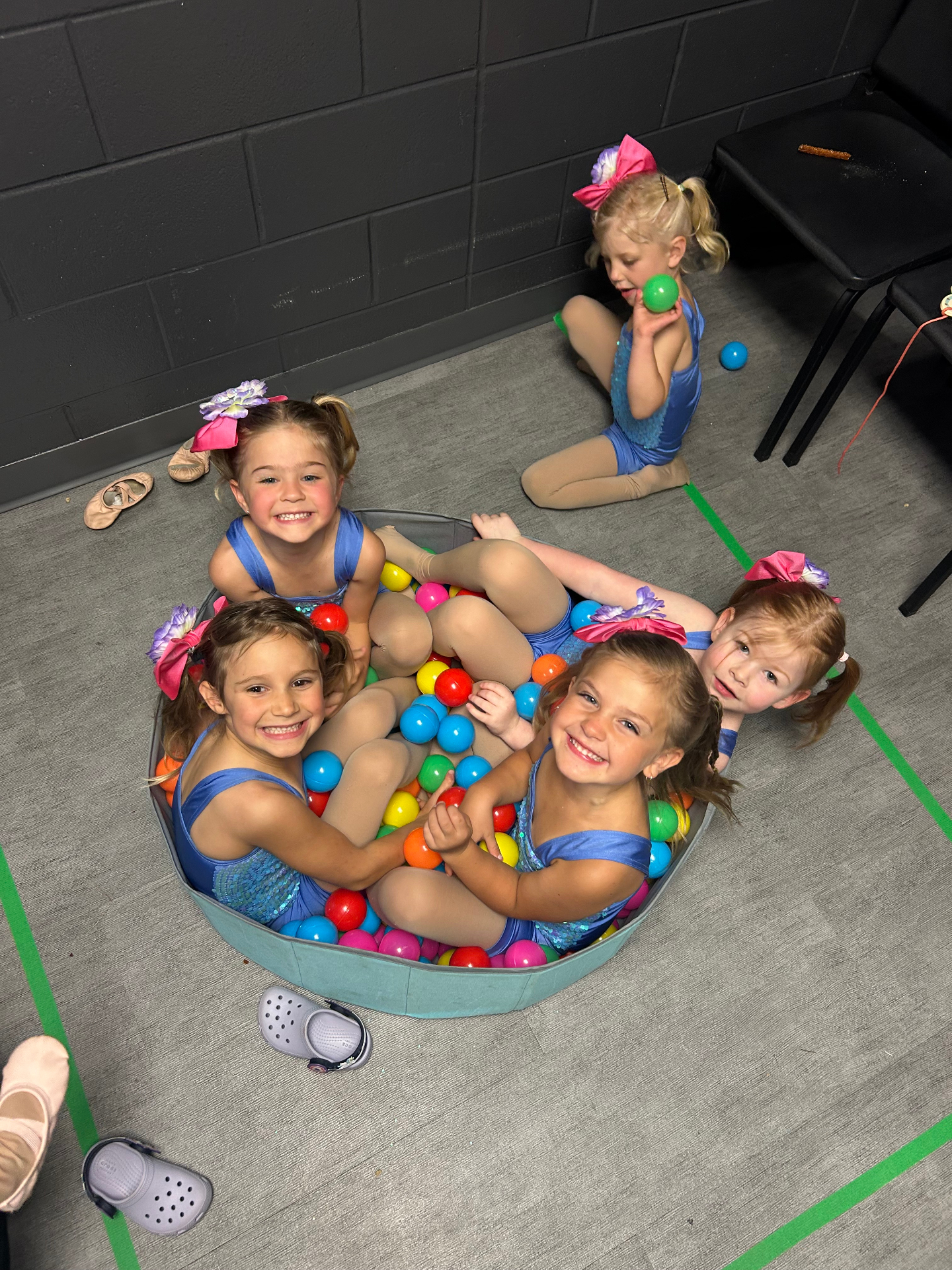 Little dancers playing in the ball pit